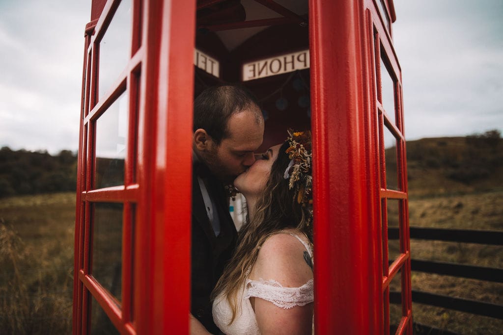 Scotland Elopement, couple cuddling in front of kilchurn castle on loch awe