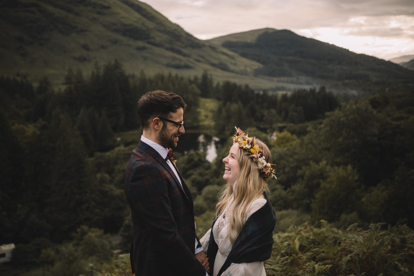 Scotland elopement. Couple laughing together at the site of Hadgrids hut