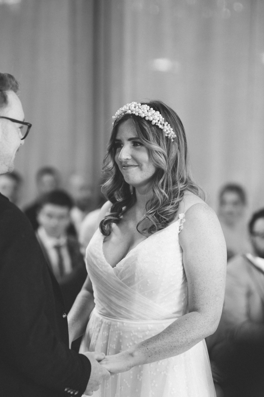 bride smiling and tearing up at groom at their grange farm wedding
