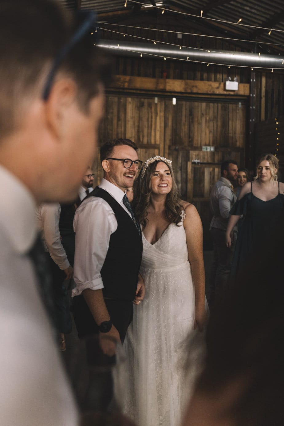groom crying while looking at his bride during their wedding, with Peak District in the background