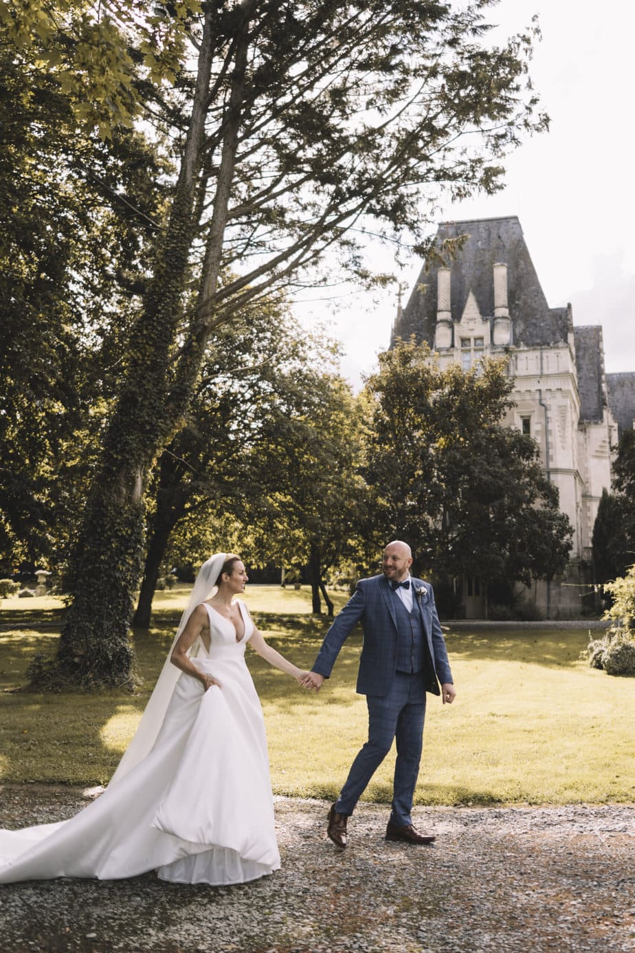 Bride and groom walking as their guests throw confetti outside Peak District church.