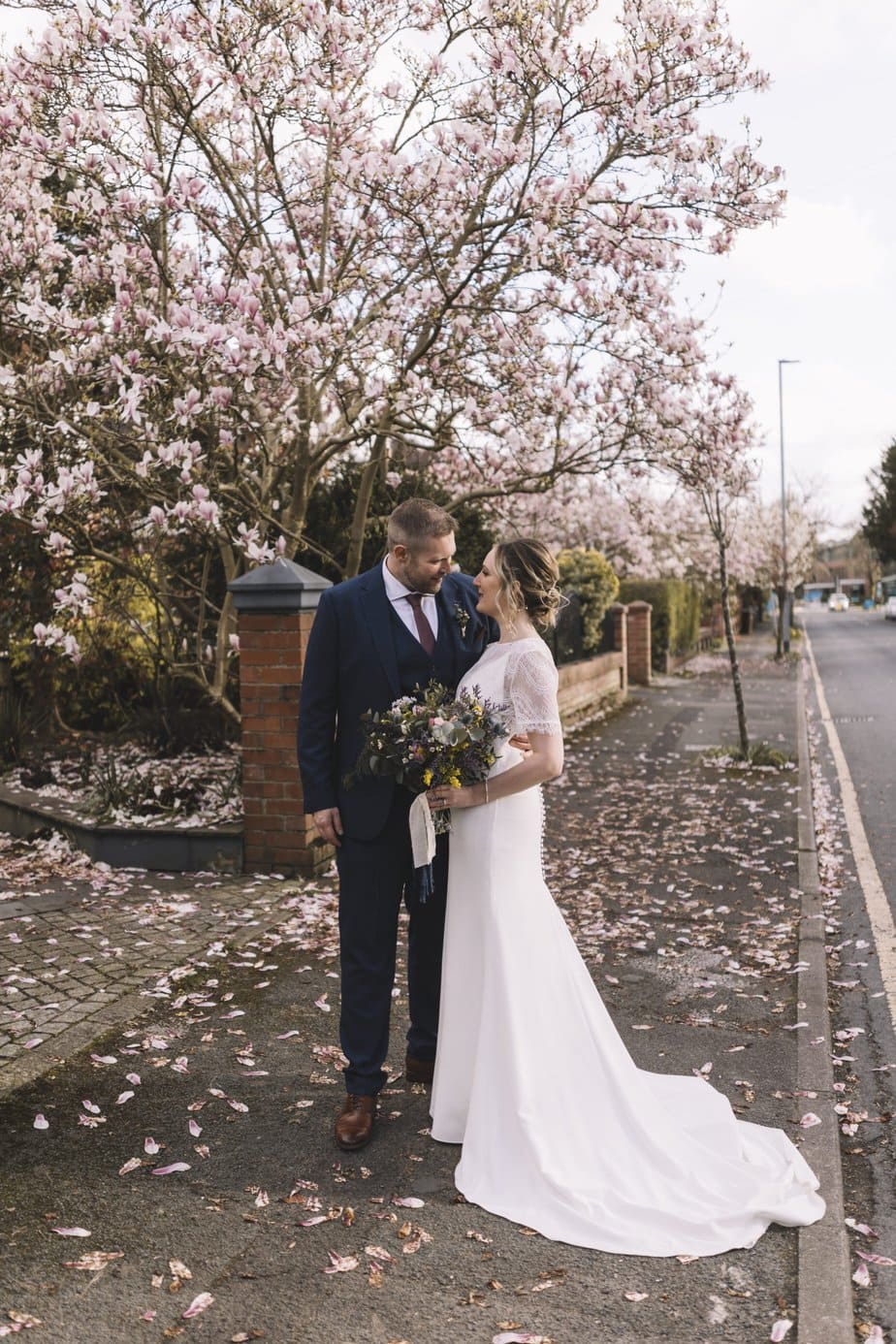 Bride and groom under magnolia tree